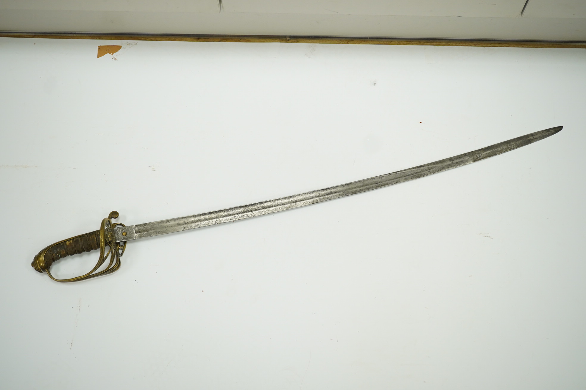 A Victorian 1845 pattern infantry officer’s sword, with regulation blade and brass hilt with folding side guard. Condition - fair, well worn over all.